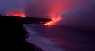 Lava meets ocean at nighttime

